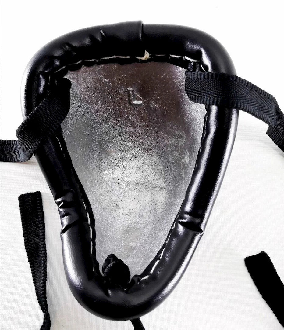 Black steel groin guard with straps on a white background