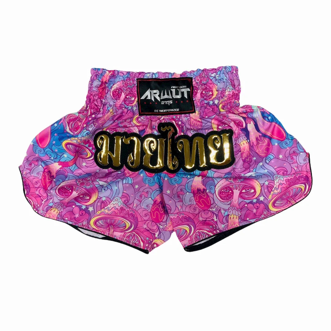 Colorful Muay Thai shorts with a golden Arwut brand label on a white background