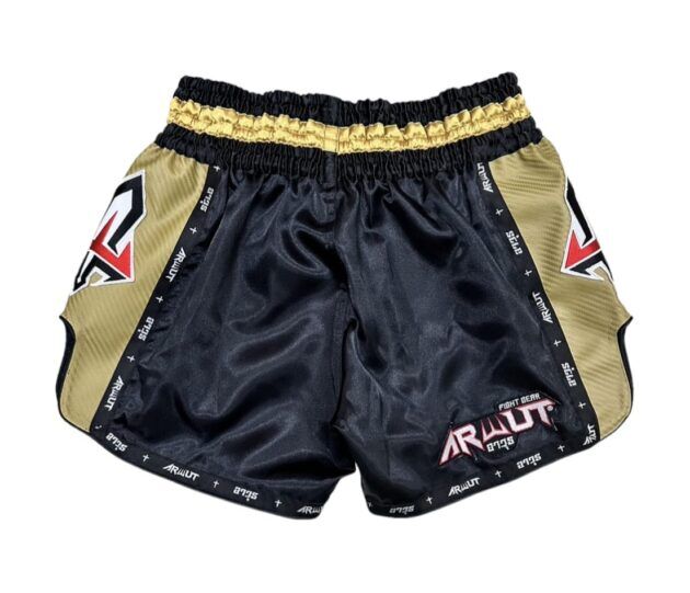 Black and gold Muay Thai shorts with branding on a white background