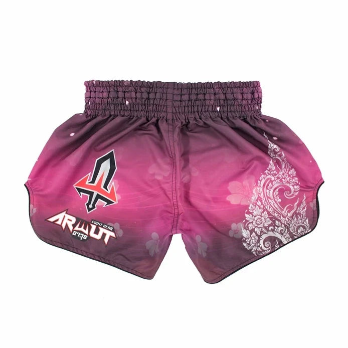 Pink Muay Thai boxing shorts with white patterns and visible branding on a white background