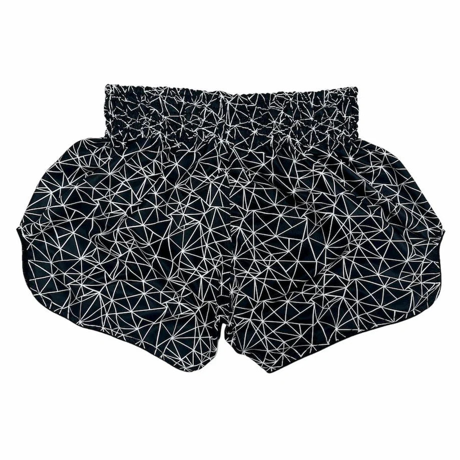 Black Muay Thai shorts with white geometric pattern on a white background