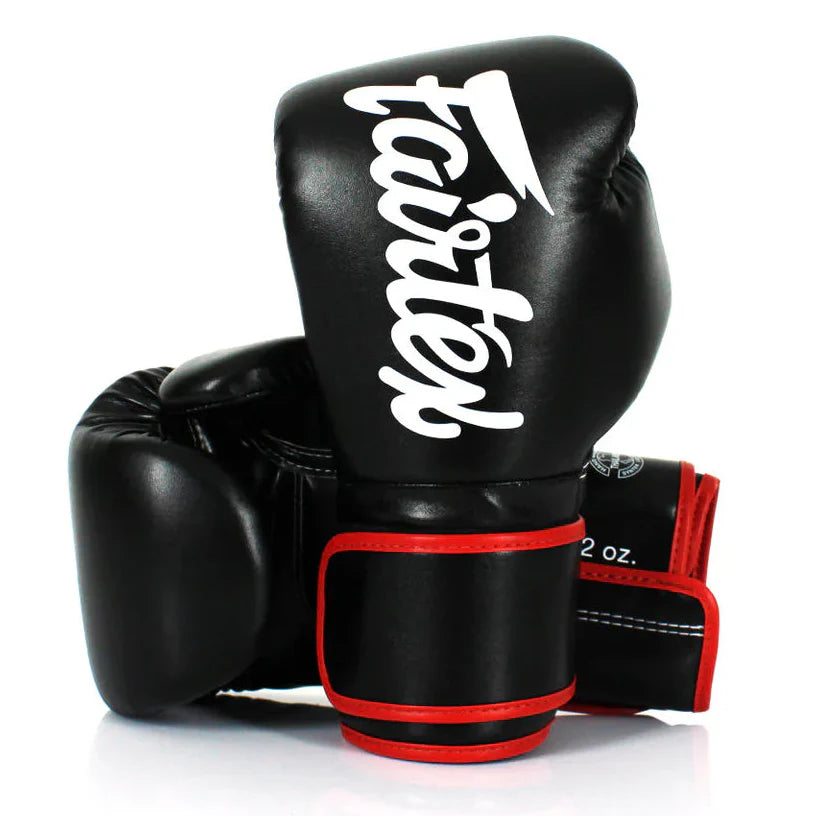 Black boxing gloves with red accents and 'Fairtex' branding on a white background