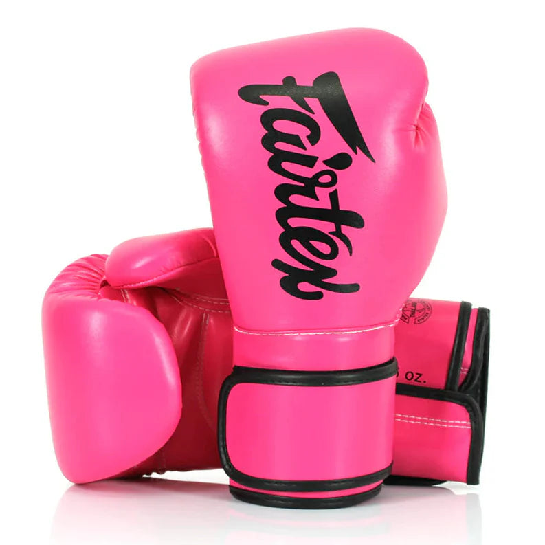 Pink boxing gloves with 'fairtex' branding on a white background