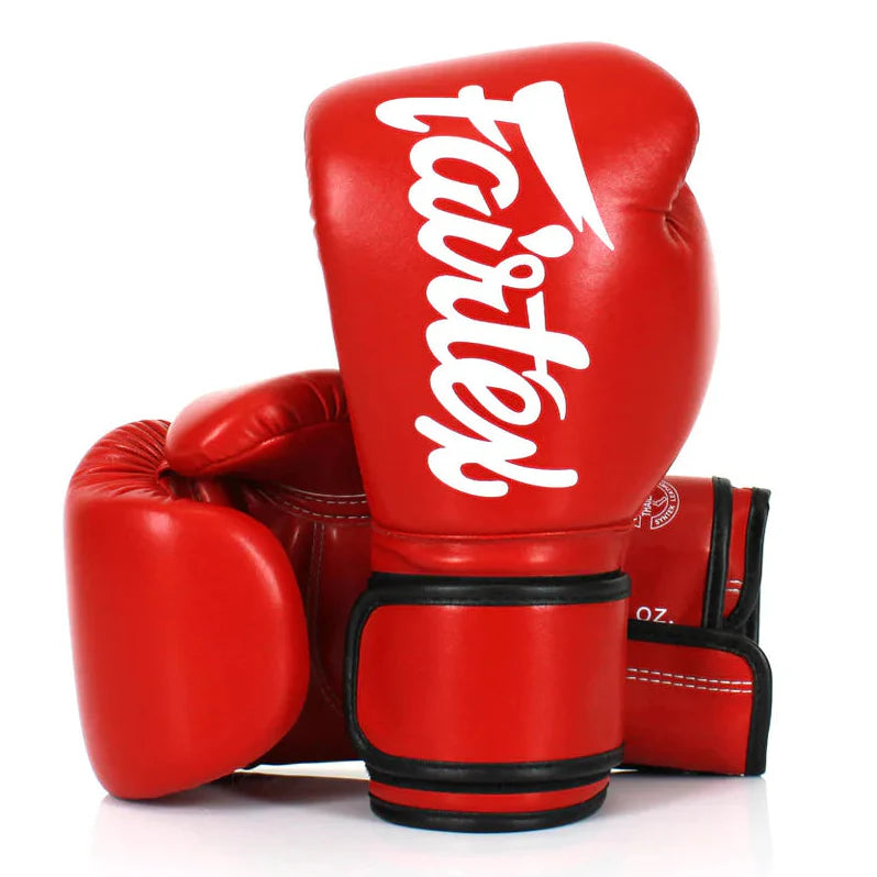 Red boxing gloves with 'Fairtex' branding on a white background