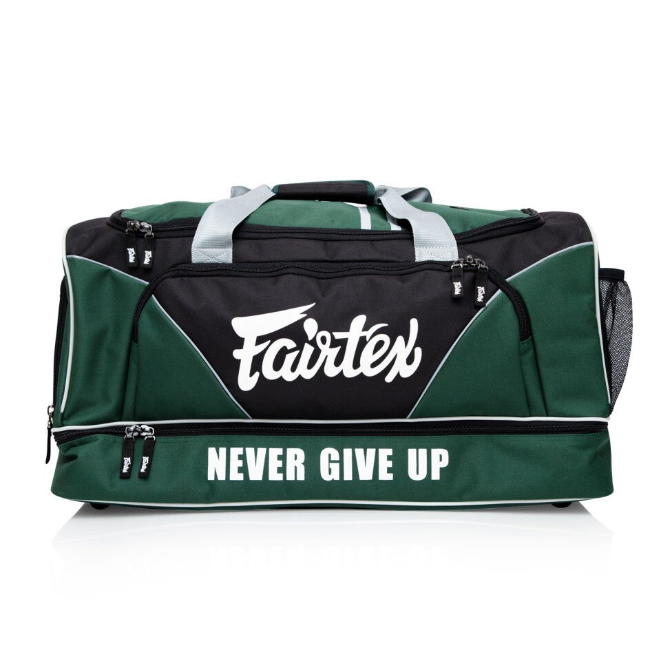 Green and black duffel bag with Fairtex logo and 'Never Give Up' text on a white background