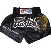 Black Muay Thai shorts with Fairtex branding and dragon design on a white background