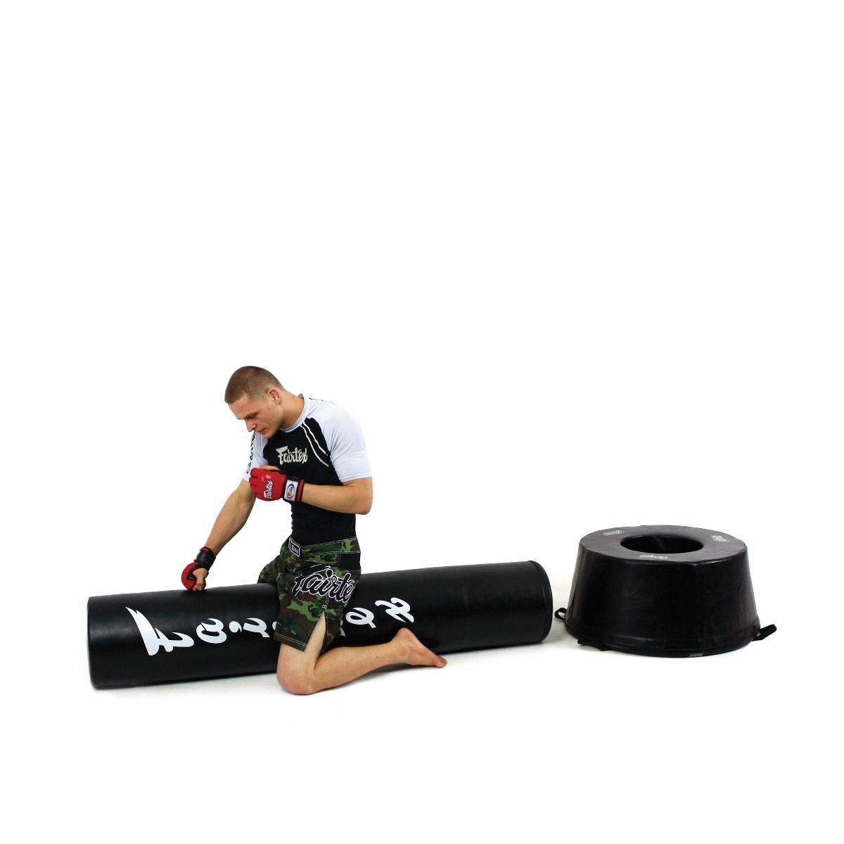 Male MMA fighters training on the Fairtex Freestanding bag on a white background