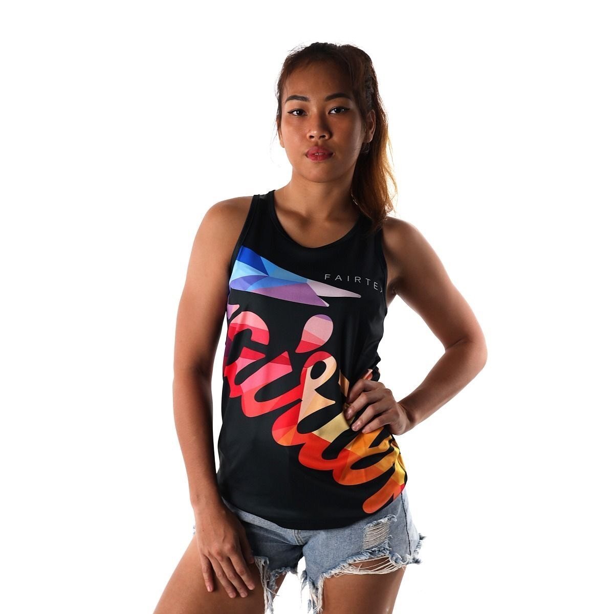 Woman wearing a black tank top with colorful graphics and text on a white background