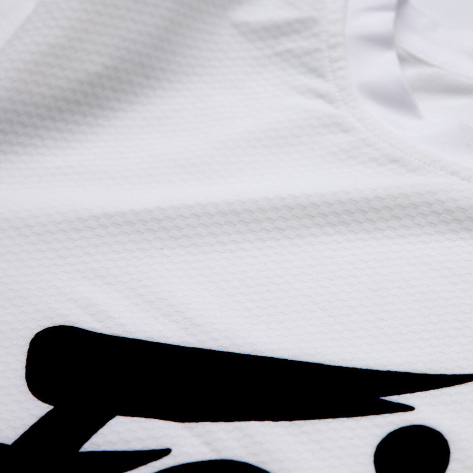 Close-up of a white shirt with a black logo on a textured fabric background