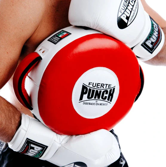Red boxing pad with 'Fuerte Punch' branding held by a person wearing white boxing gloves.