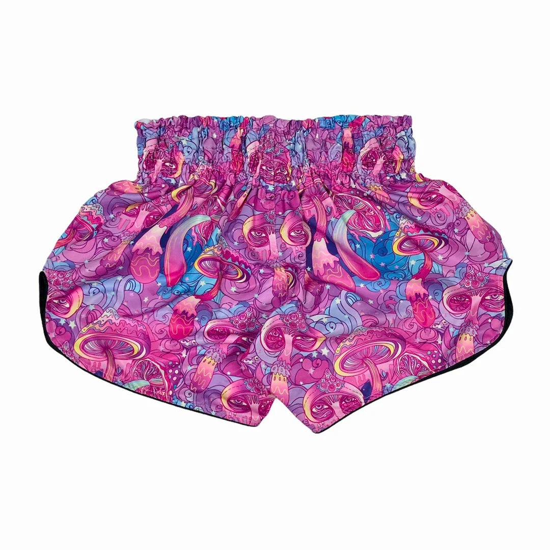 Colorful patterned Muay Thai shorts on a white background