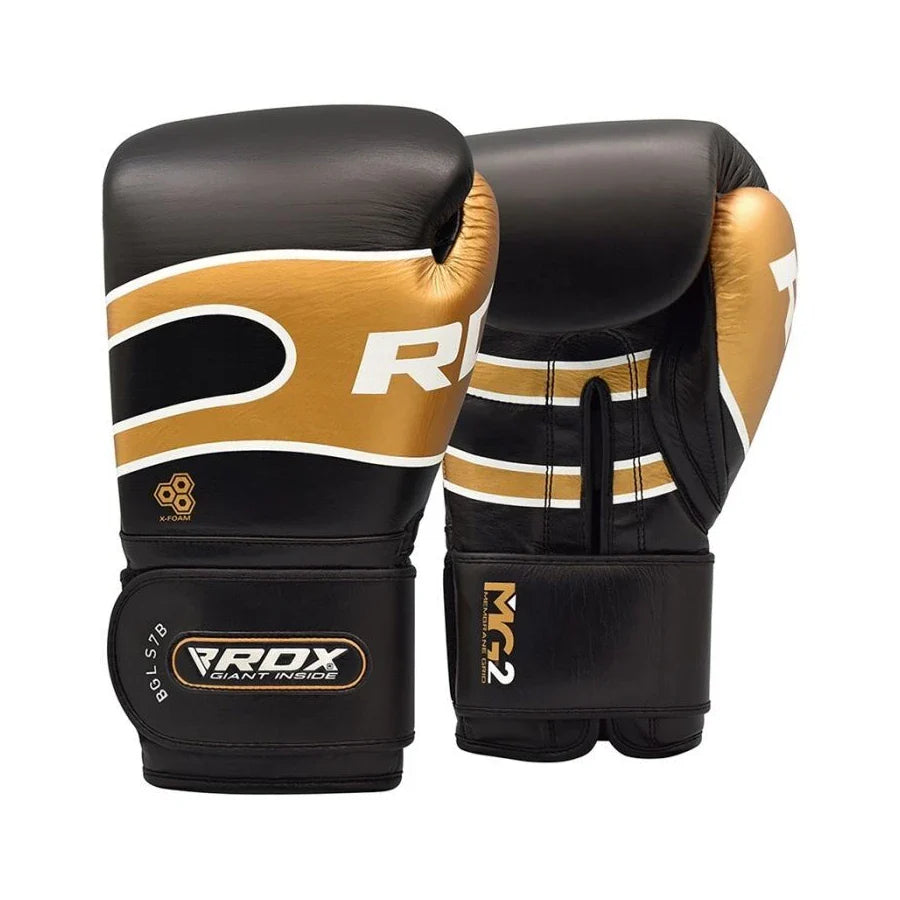 Pair of black and gold RDX boxing gloves with visible branding on a white background