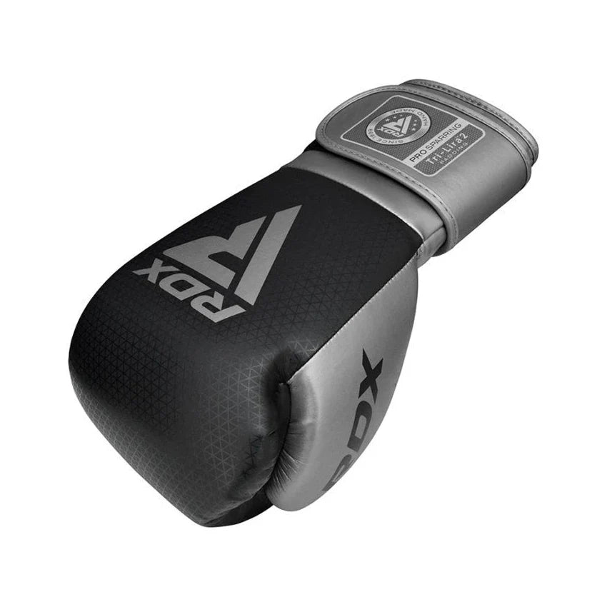 Black and gray boxing glove with RDX branding on a white background