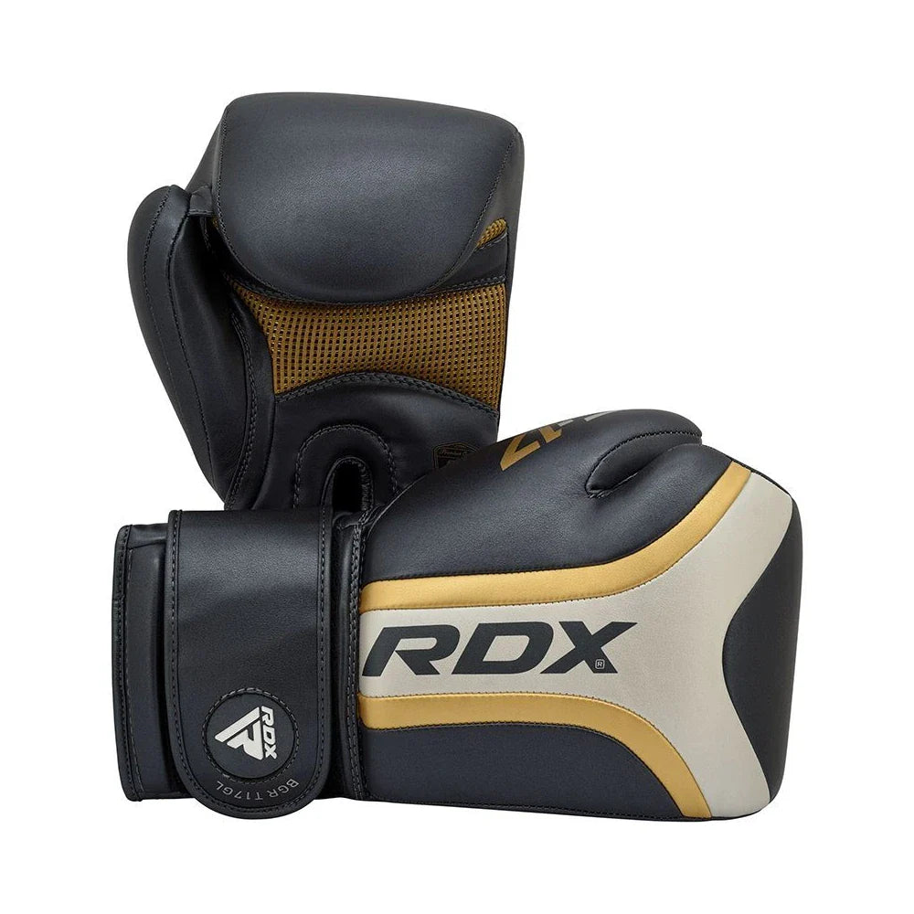 Pair of black and gold boxing gloves with RDX branding on a white background