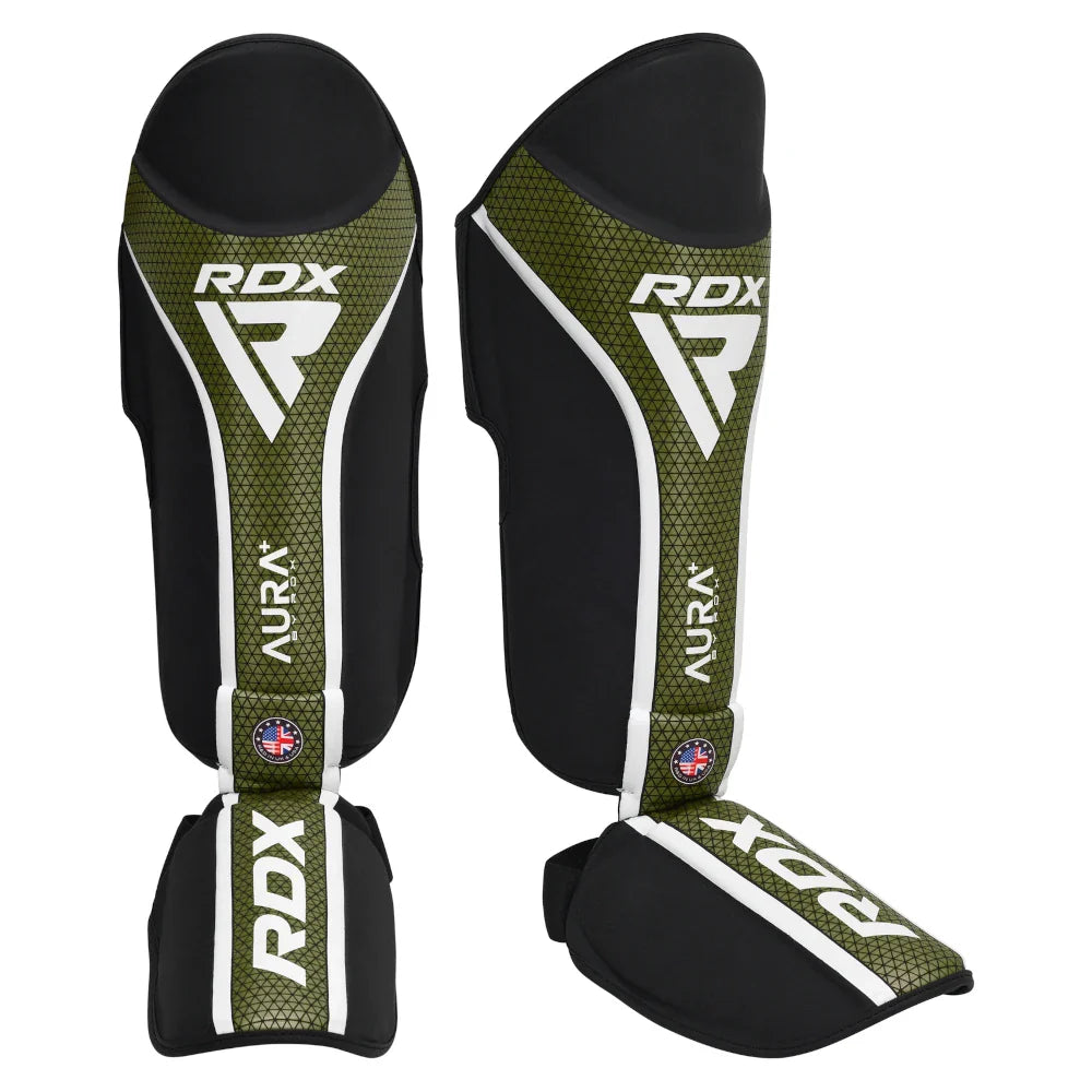 Pair of RDX shin guards with green and black design on a white background