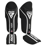 Black RDX shin guards with white accents on a white background