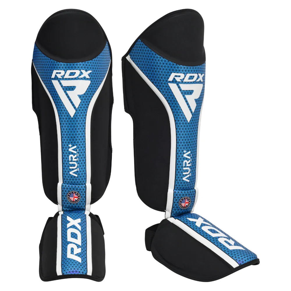 Pair of RDX blue and black shin guards on a white background