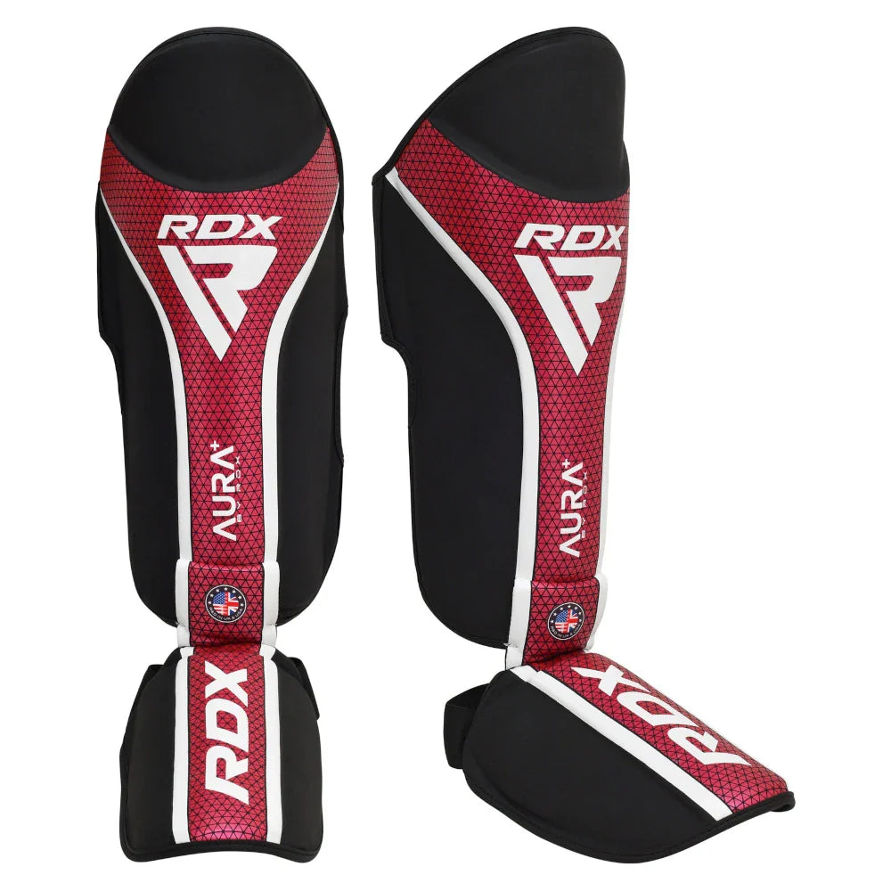 Pair of red and black RDX shin guards on a white background