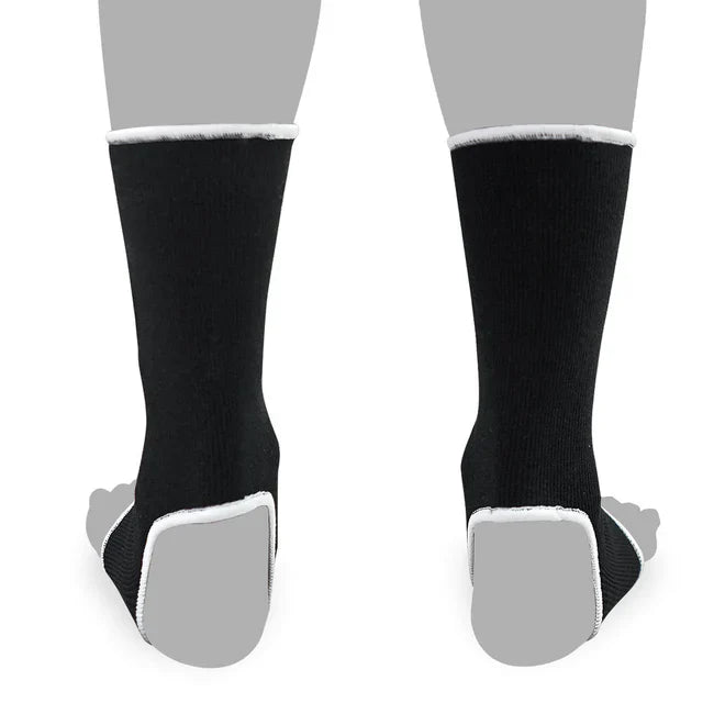 Black anklets with white soles on a gray background