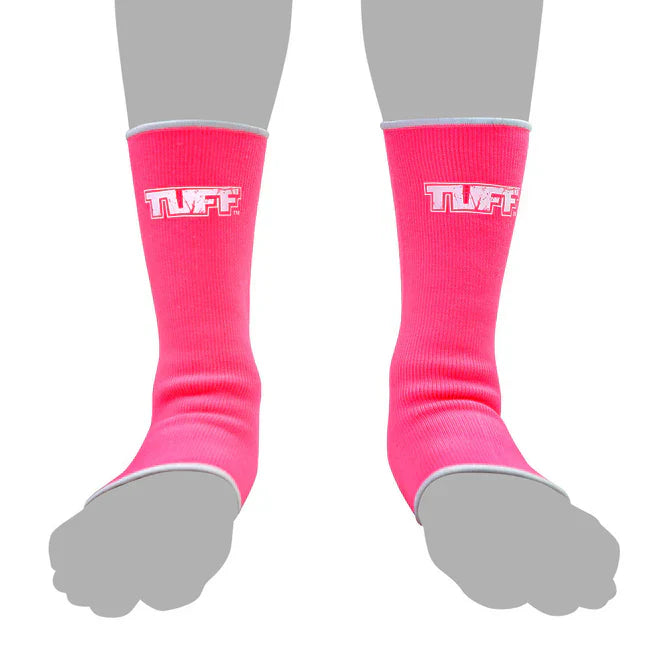 Pink anklets with 'TUFF' logo worn by a person on a white background