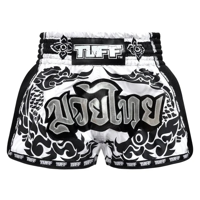 Black and white Muay Thai shorts with 'TUFF' branding on a white background