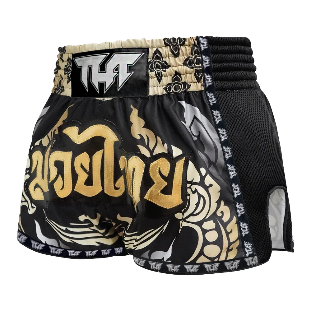 Black and gold Muay Thai shorts with TUFF branding on a white background