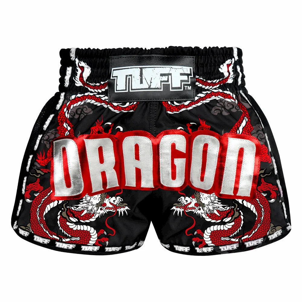 Black Muay Thai shorts with red and white dragon design and 'TUFF' brand label on a white background
