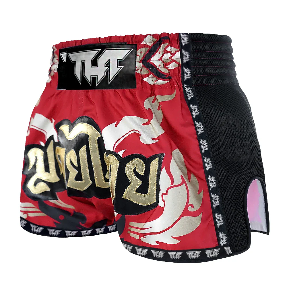 Red and black Muay Thai shorts with white designs on a white background