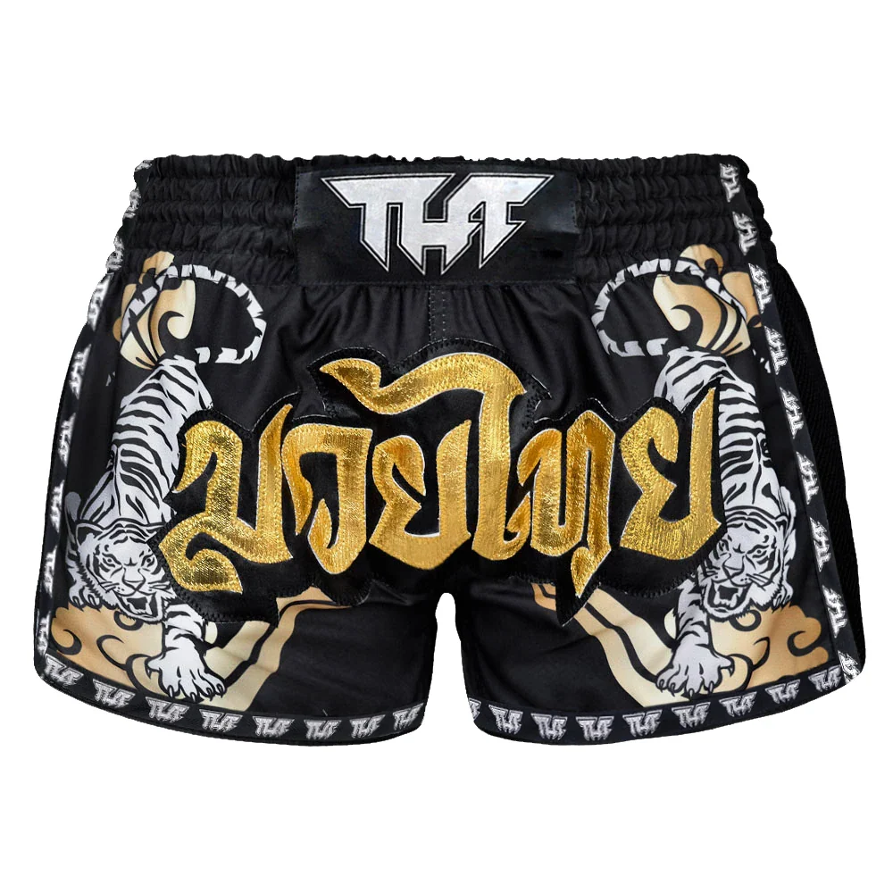 Black Muay Thai shorts with gold text and tiger designs on a white background