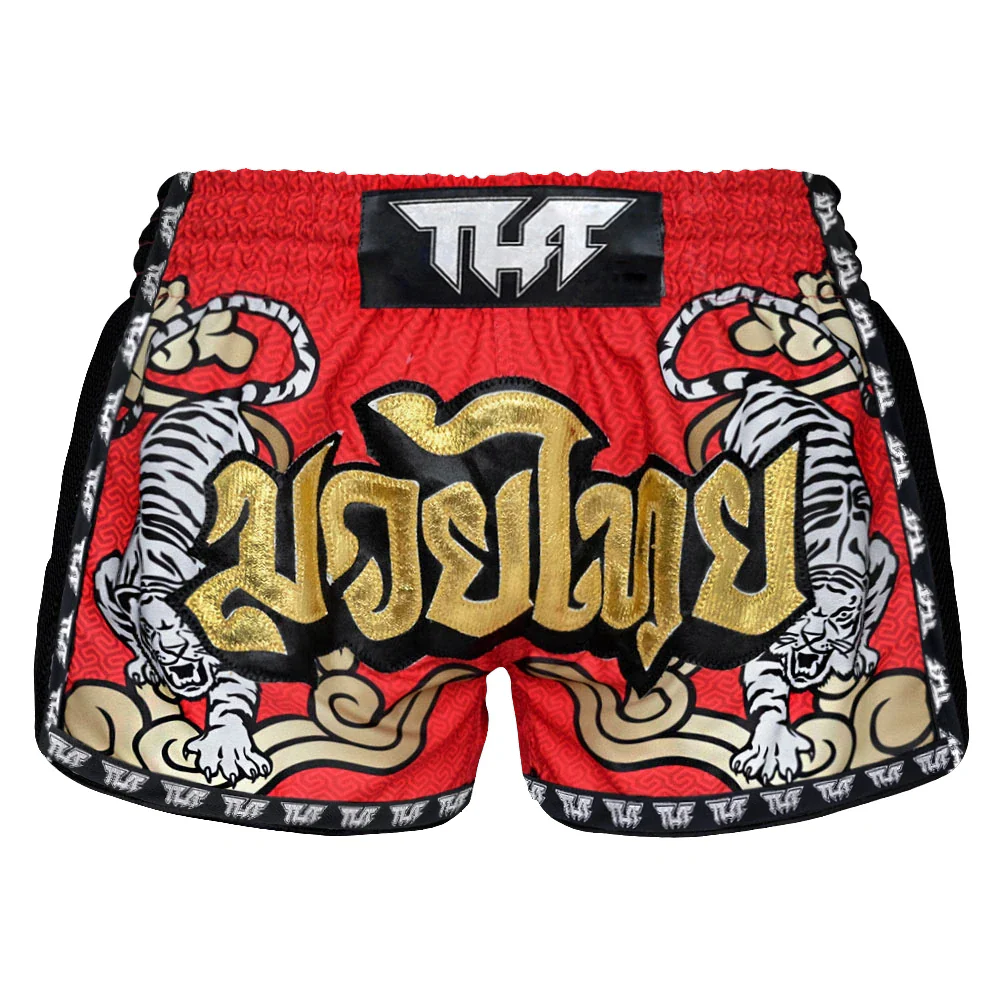 Red Muay Thai shorts with gold text and tiger design on a white background