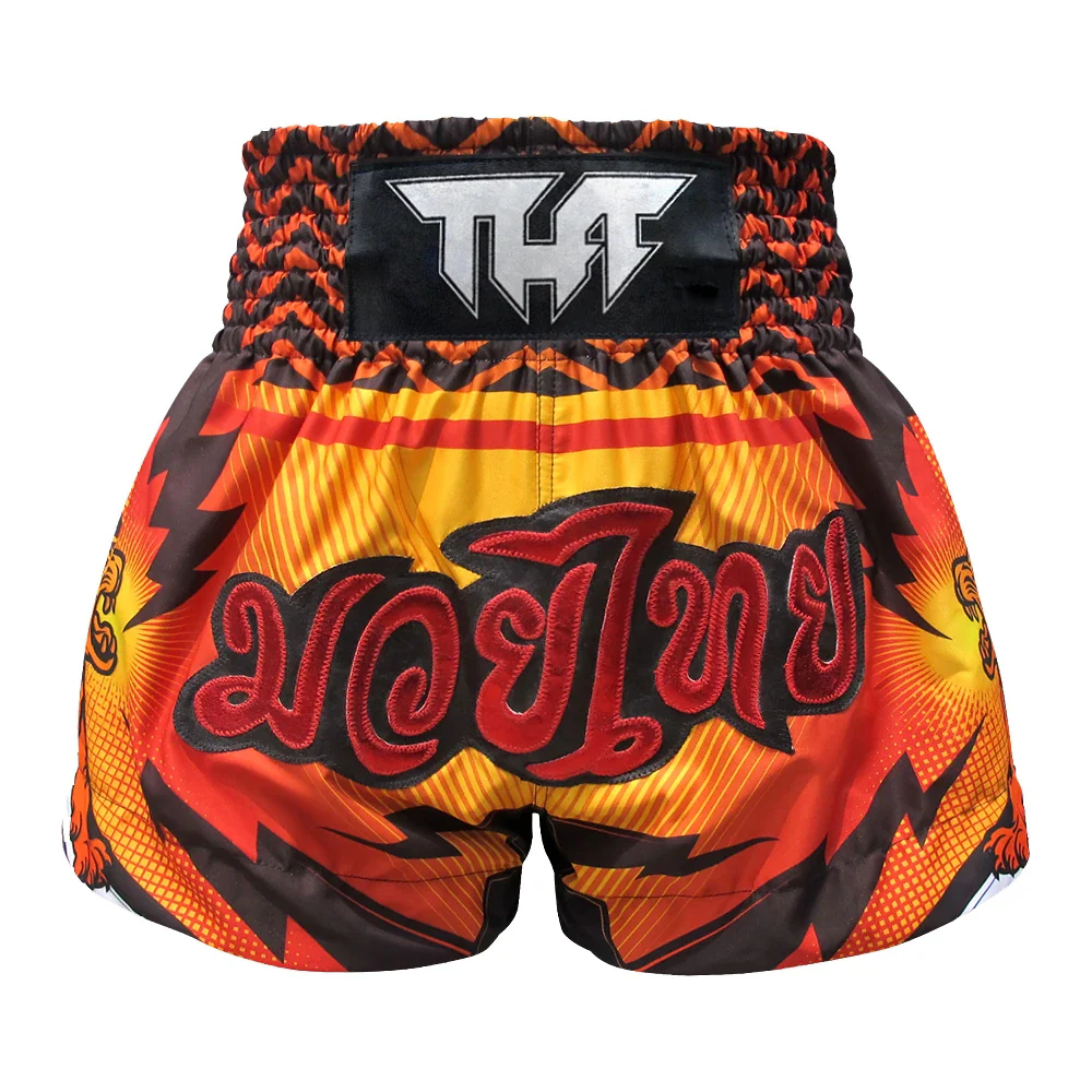 Orange and black Muay Thai shorts with a prominent logo on a white background