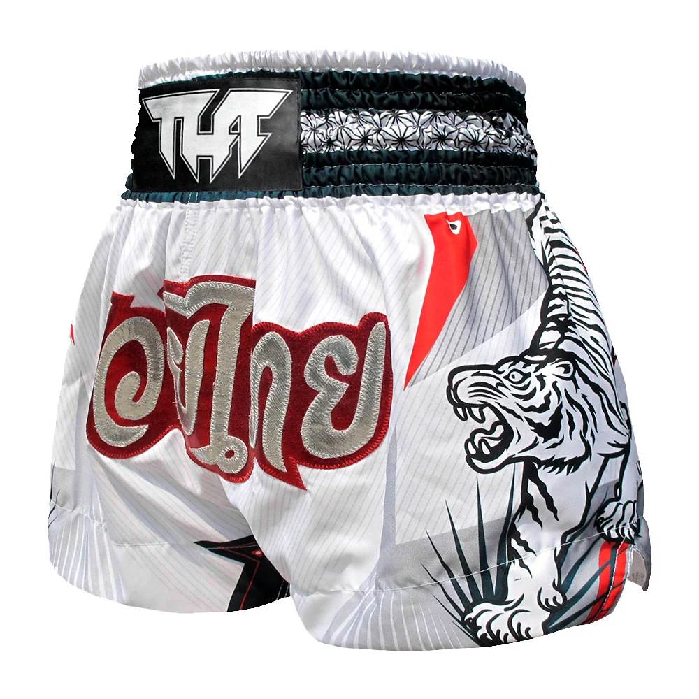 White Muay Thai shorts with red text and tiger design on a white background