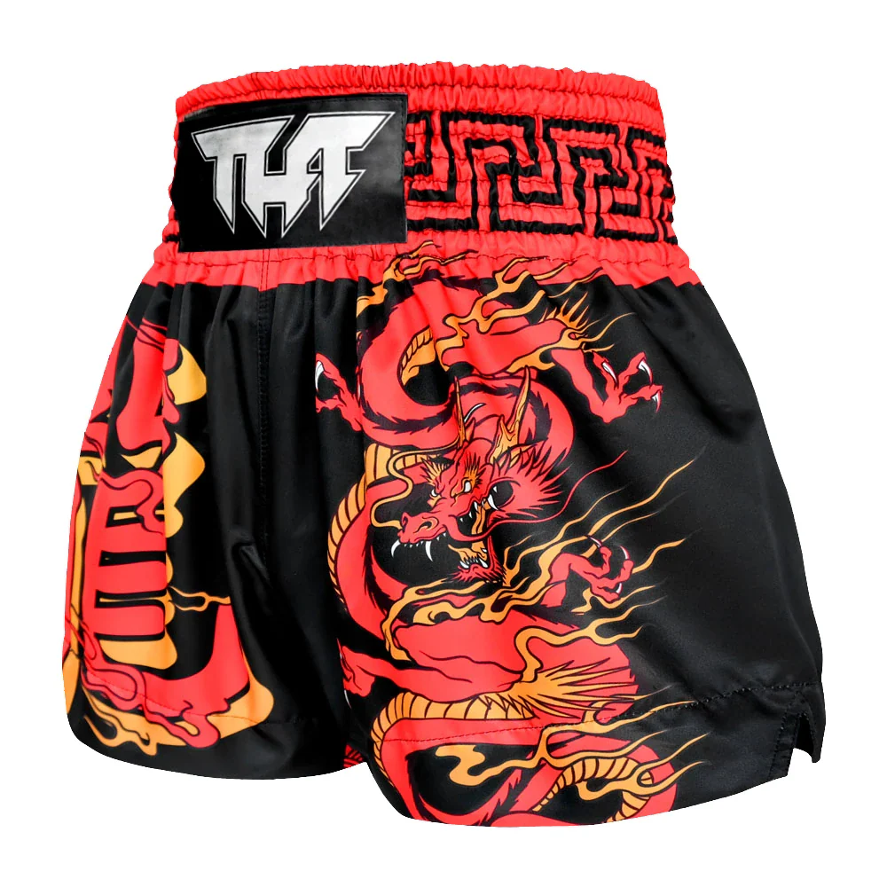 Black and red Muay Thai shorts with dragon design on a white background