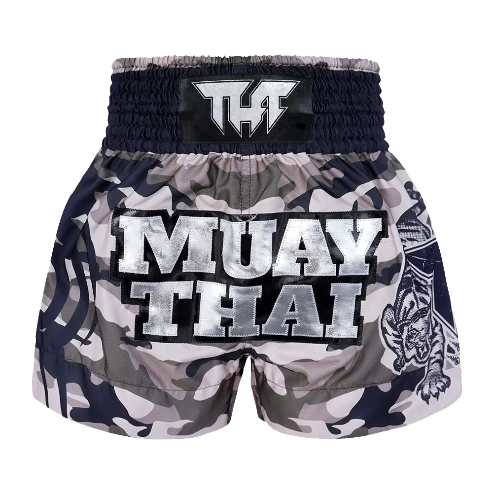 Camouflage Muay Thai shorts with 'Muay Thai' text and tiger design on a white background