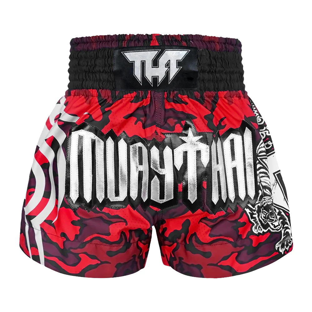 Red and black Muay Thai shorts with white text on a white background
