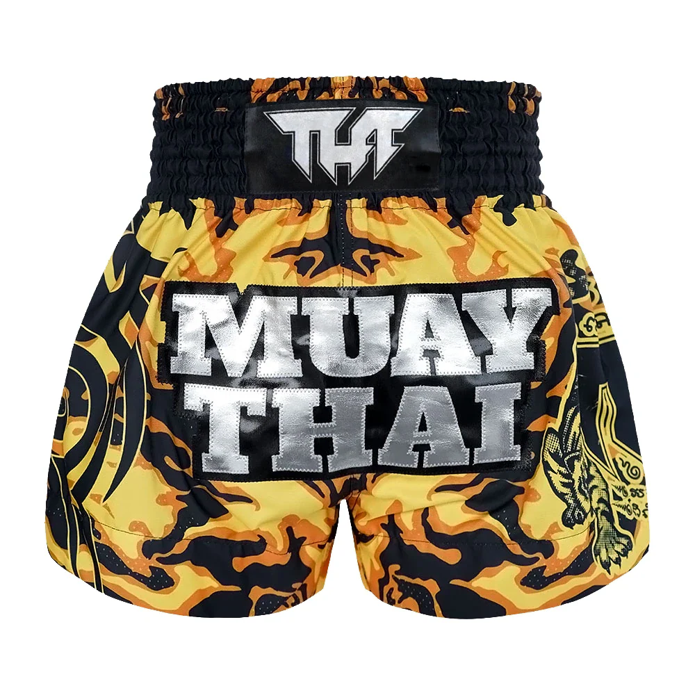 Yellow and black Muay Thai shorts with 'Tuff' logo on a white background