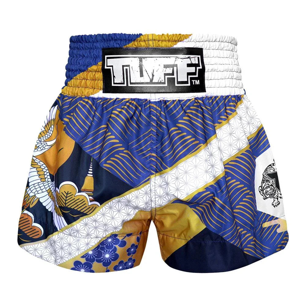 Colorful Muay Thai shorts with a brand logo on a white background