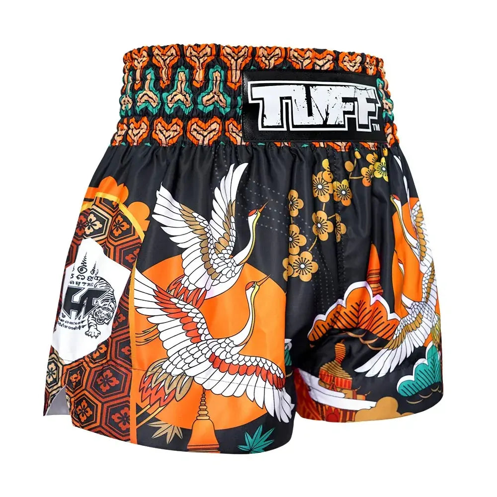 Colorful Muay Thai shorts with intricate designs and 'TUFF' branding on a white background