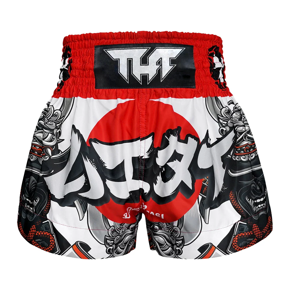 Muay Thai shorts with red, black, and white design on a white background