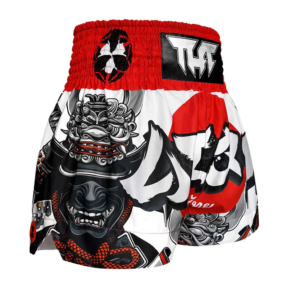 Muay Thai shorts with a dragon design and red waistband on a white background
