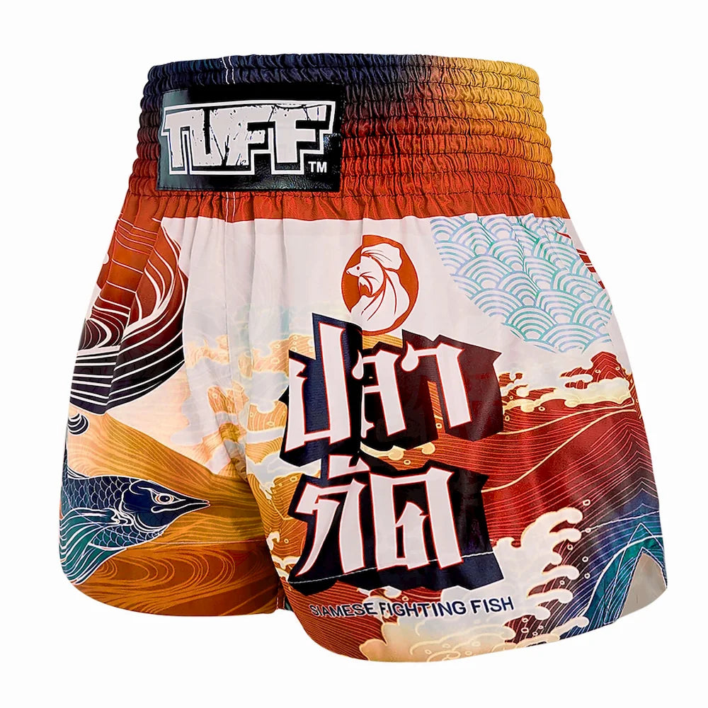 Colorful Muay Thai boxing shorts with a design and brand logo on a white background