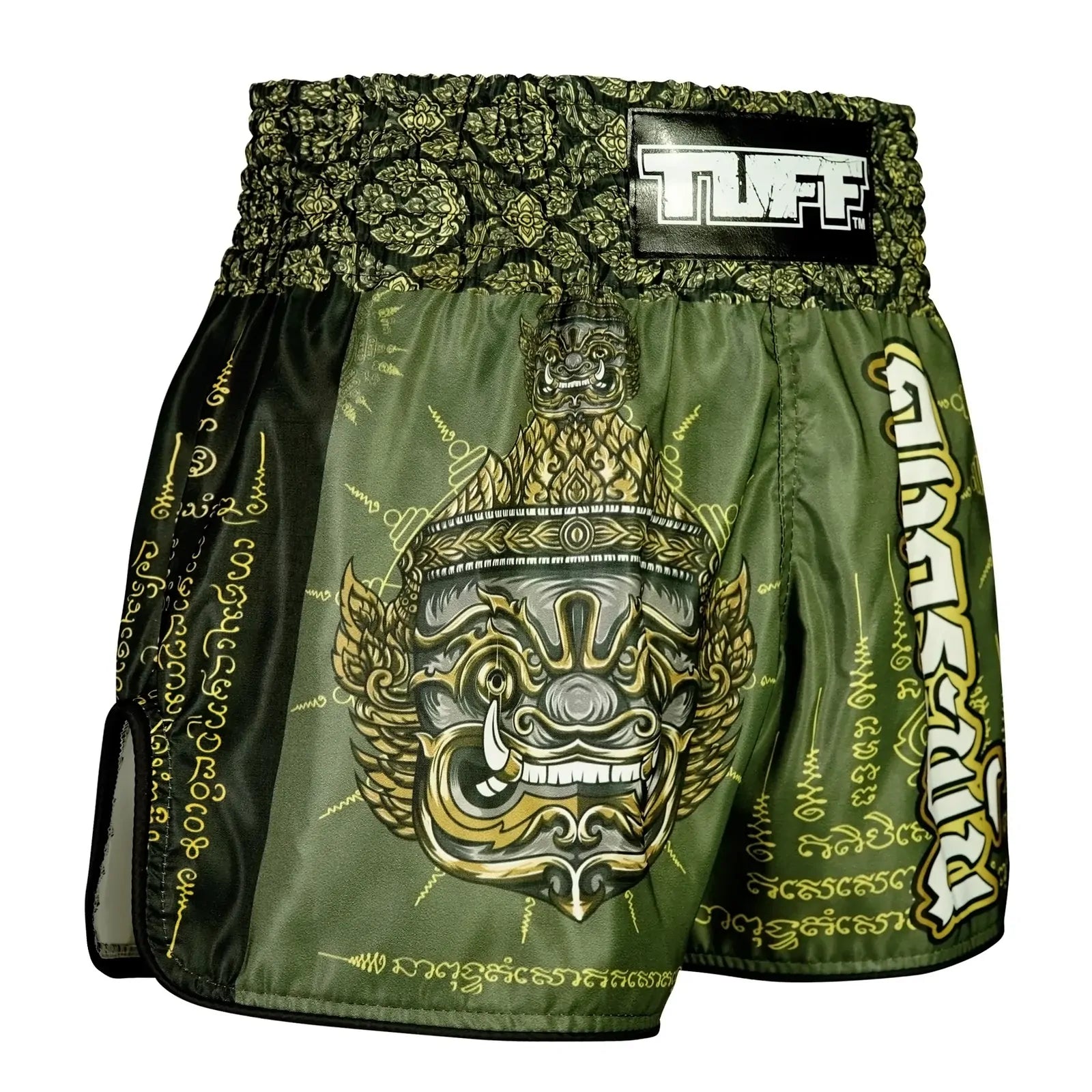 Green and gold Muay Thai shorts with intricate designs on a white background