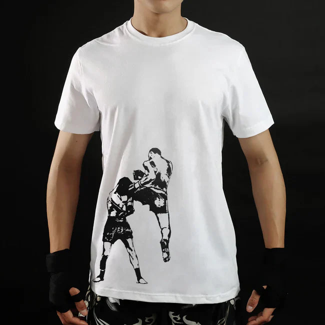 Person wearing a white t-shirt with a black and white graphic of two thai boxers on a black background