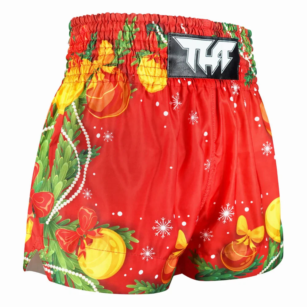 Red Muay Thai boxing shorts with Christmas-themed decorations on a white background