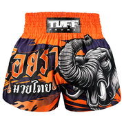Orange and black Muay Thai shorts with a elephant design on a white background