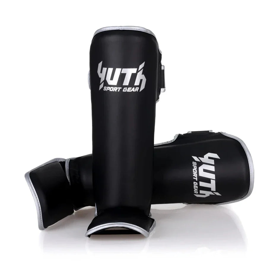Black shin guards with 'Yuth Sport Gear' branding on a white background