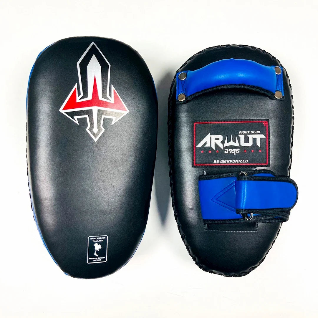 Pair of black and blue Muay Thai pads with visible branding on a white background