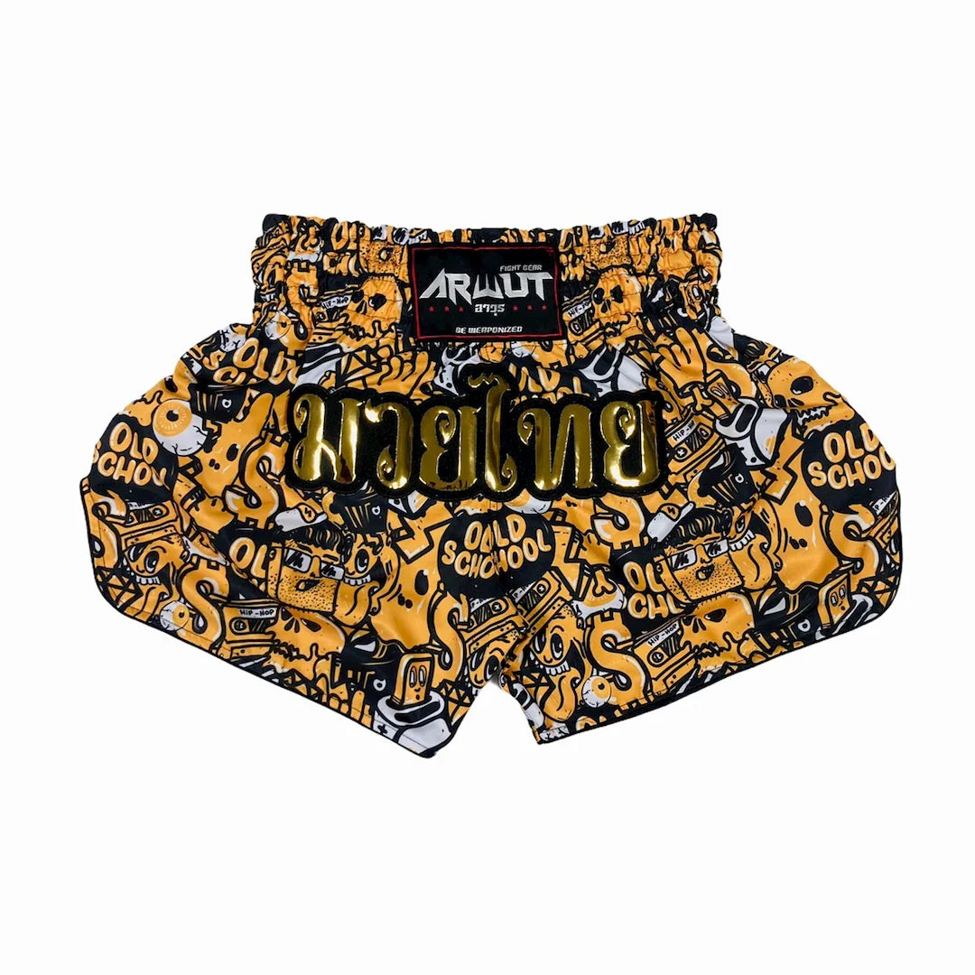 Muay Thai shorts with yellow and black graphic design on a white background