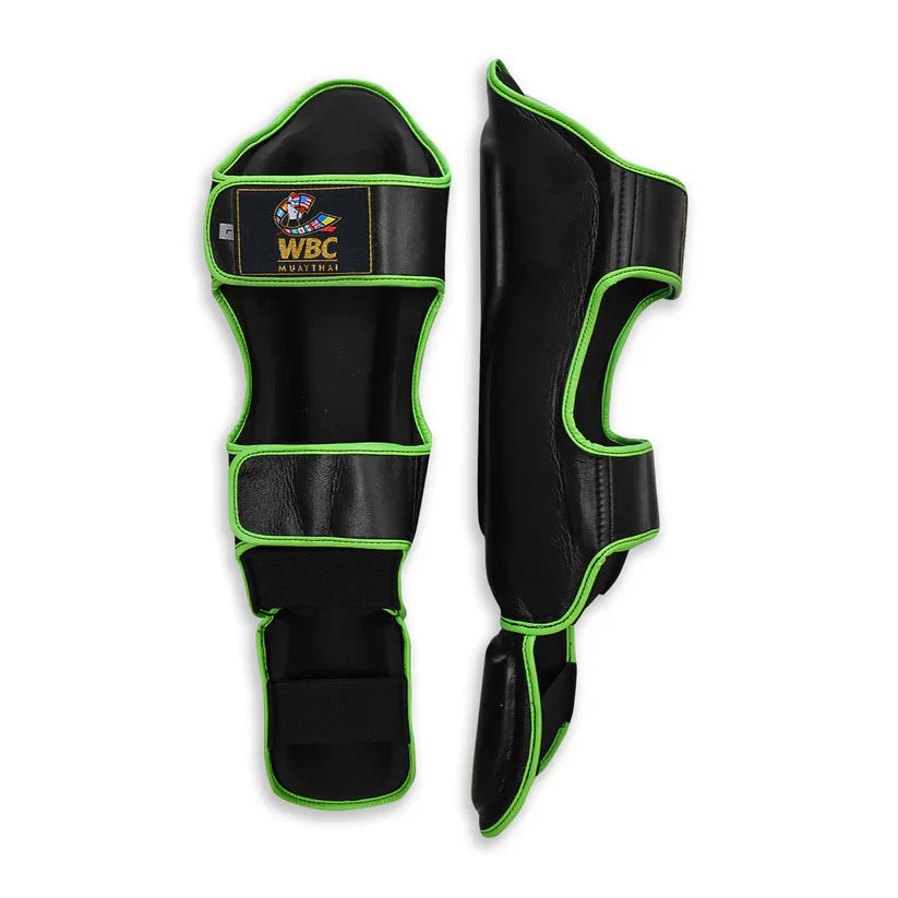Black and green shin guards with WBC logo on a white background