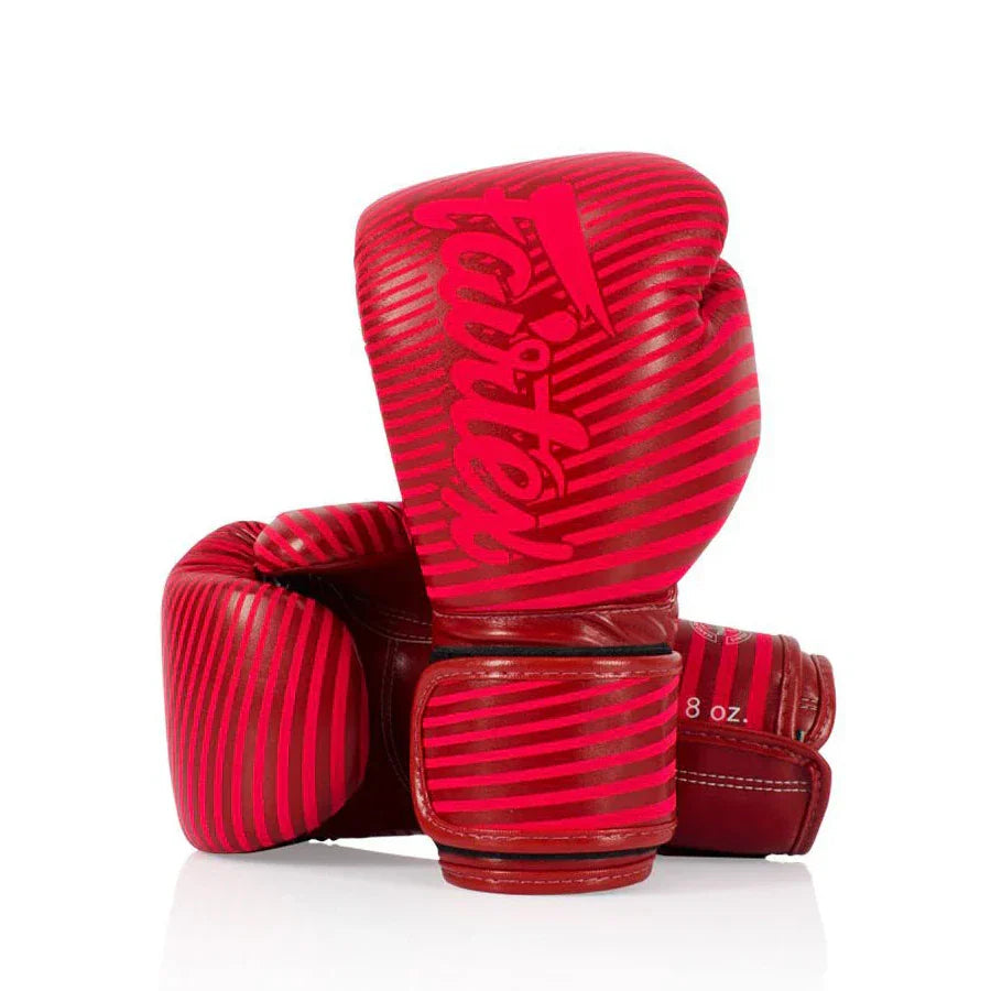 Red boxing gloves with a Fairtex brand logo on a white background